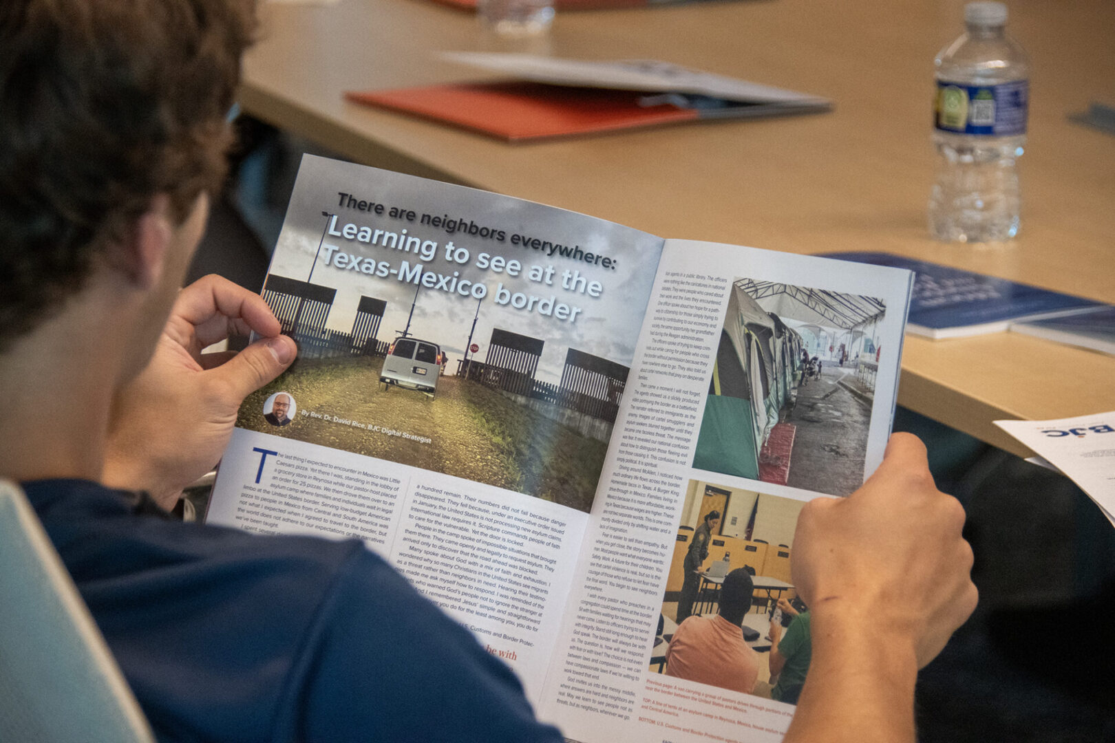 A person is reading a magazine featuring images and articles related to rescue operations in floods.