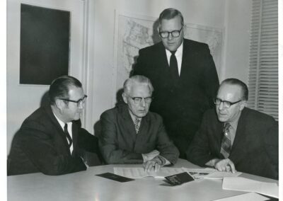 1970 The staff of BJC in the conference room. Pictured left to right are W. Barry Garrett (Director of Information Services), C. Emanuel Carlson (Executive Director), John W. Baker (Associate Executive Director and Director of Research), and James M. Sapp (Director of Information Services and Editor of Report from the Capital).